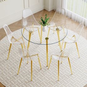 A modern minimalist style round transparent tempered glass table with gold metal legs